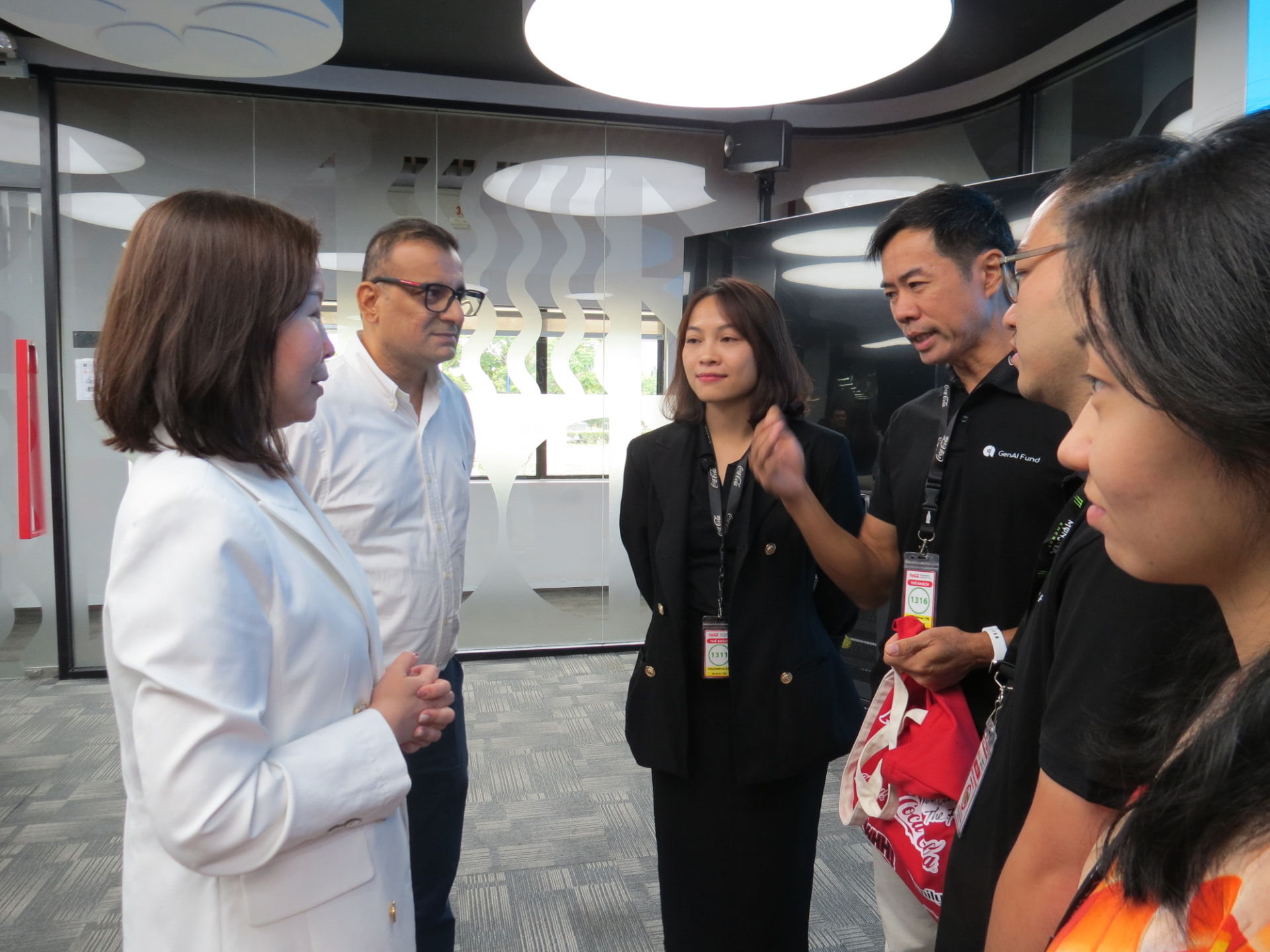 GenAI Fund and enterprise leaders in discussion during an on-site workforce training and onboarding review at an FMCG facility.