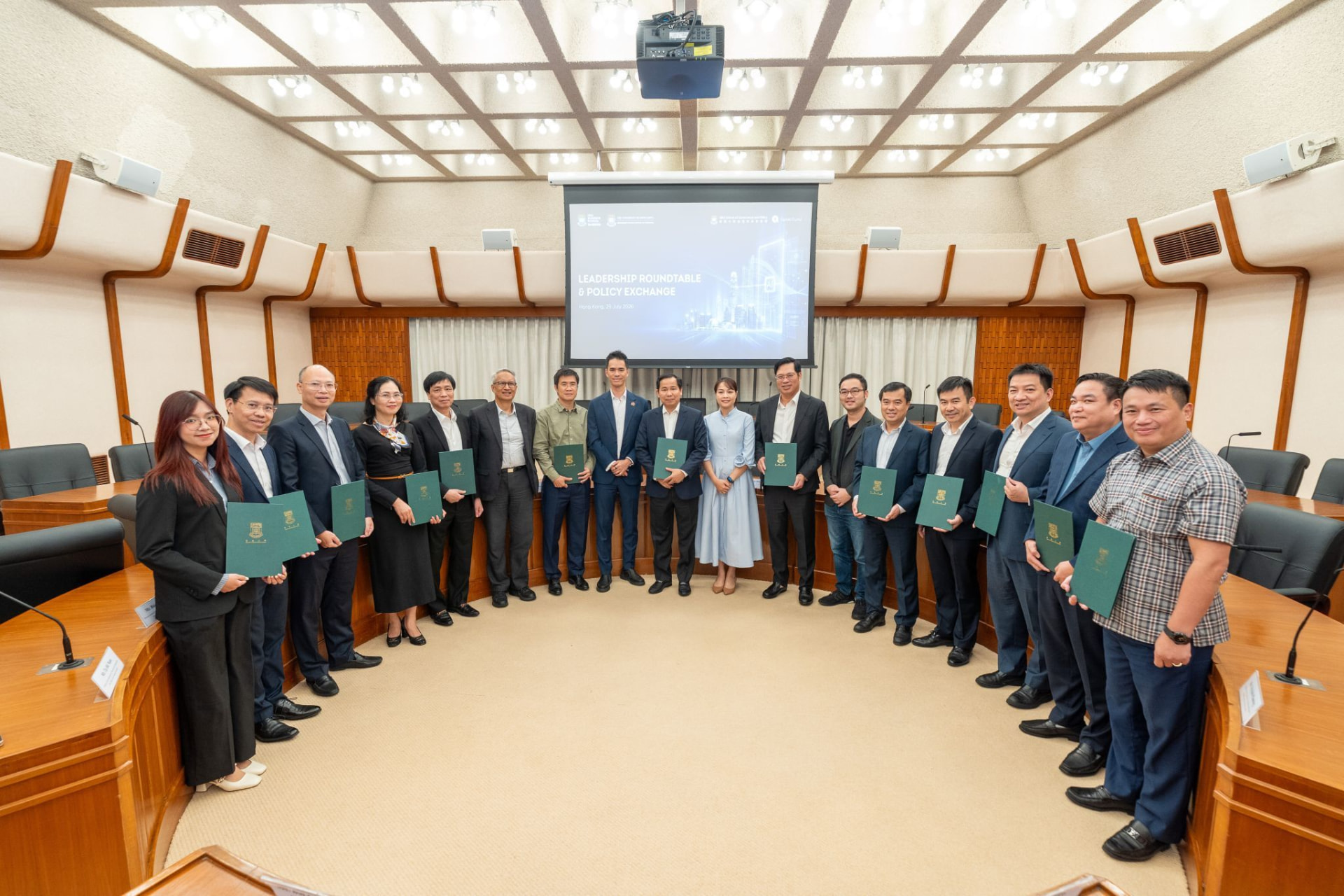 Leadership Roundtable & Policy Exchange in Hong Kong: the Vietnam National Assembly Office delegation and HKU faculty standing together in the council chamber with folders after the 29 July 2026 policy exchange session.