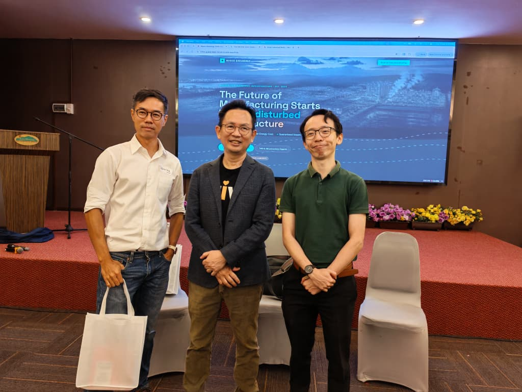 Three facilitators standing in front of a screen at the Working Backwards and vibe-coding workshop for a leading energy provider.